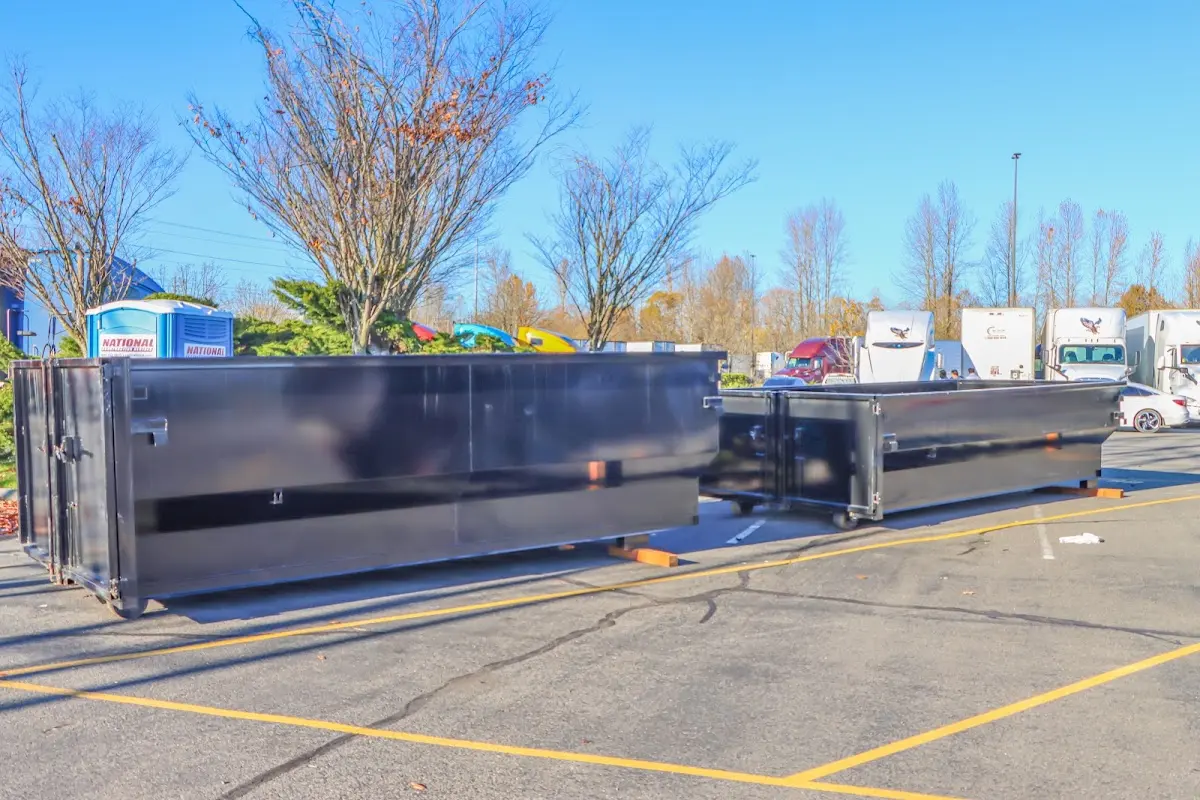 Professional dumpster rental service with roll-off container on residential driveway in Farmers Branch